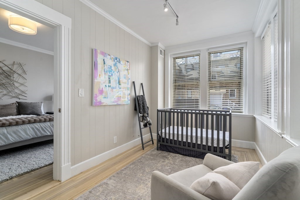 14 Warwick Road, Unit 1 Brookline, MA 02445 - Photo 13 of 29 a bedroom with furniture and a window