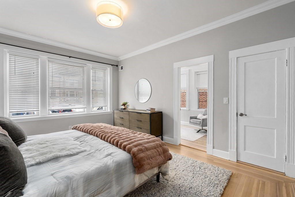 14 Warwick Road, Unit 1 Brookline, MA 02445 - Photo 14 of 29 a spacious bedroom with a large bed and a dresser
