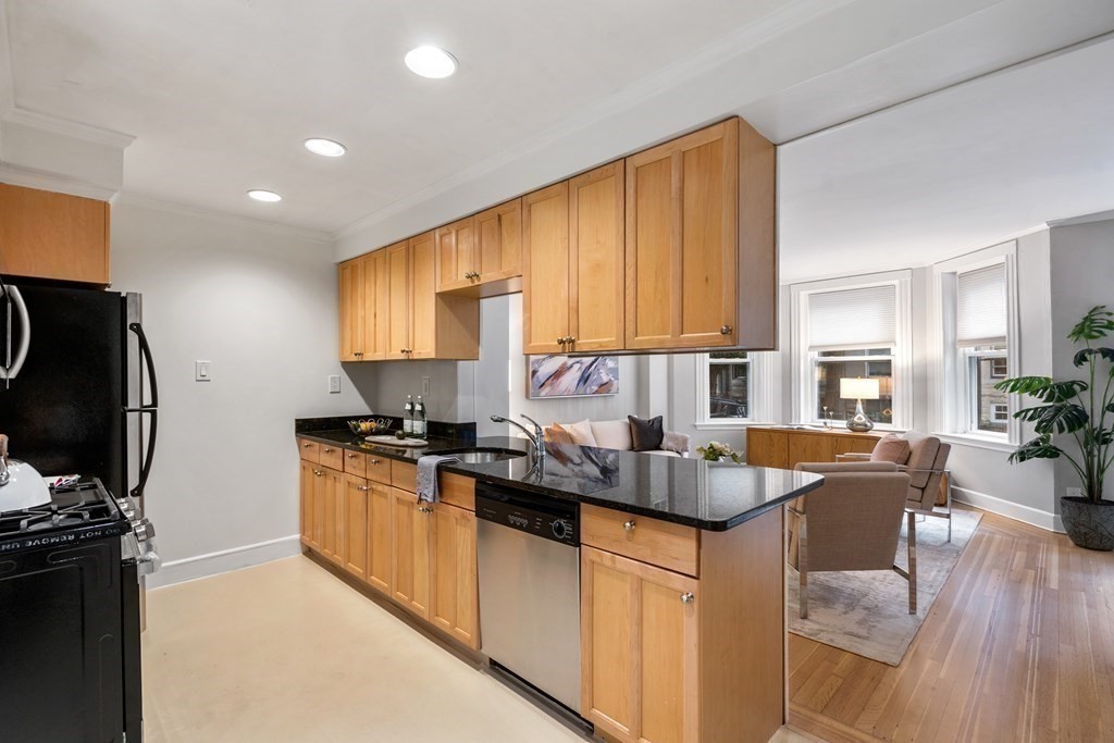 14 Warwick Road, Unit 1 Brookline, MA 02445 - Photo 7 of 29 a kitchen with granite countertop kitchen island stainless steel appliances a stove a sink a refrigerator and a microwave