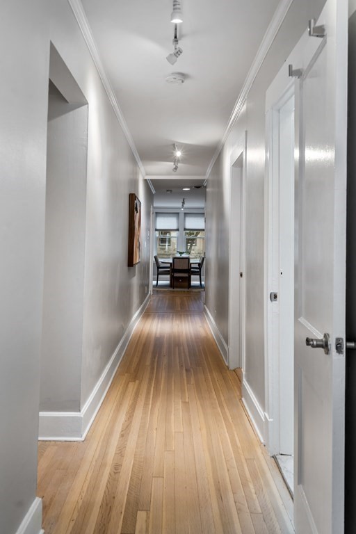 14 Warwick Road, Unit 1 Brookline, MA 02445 - Photo 8 of 29 a view of a hallway view with wooden floor and furniture