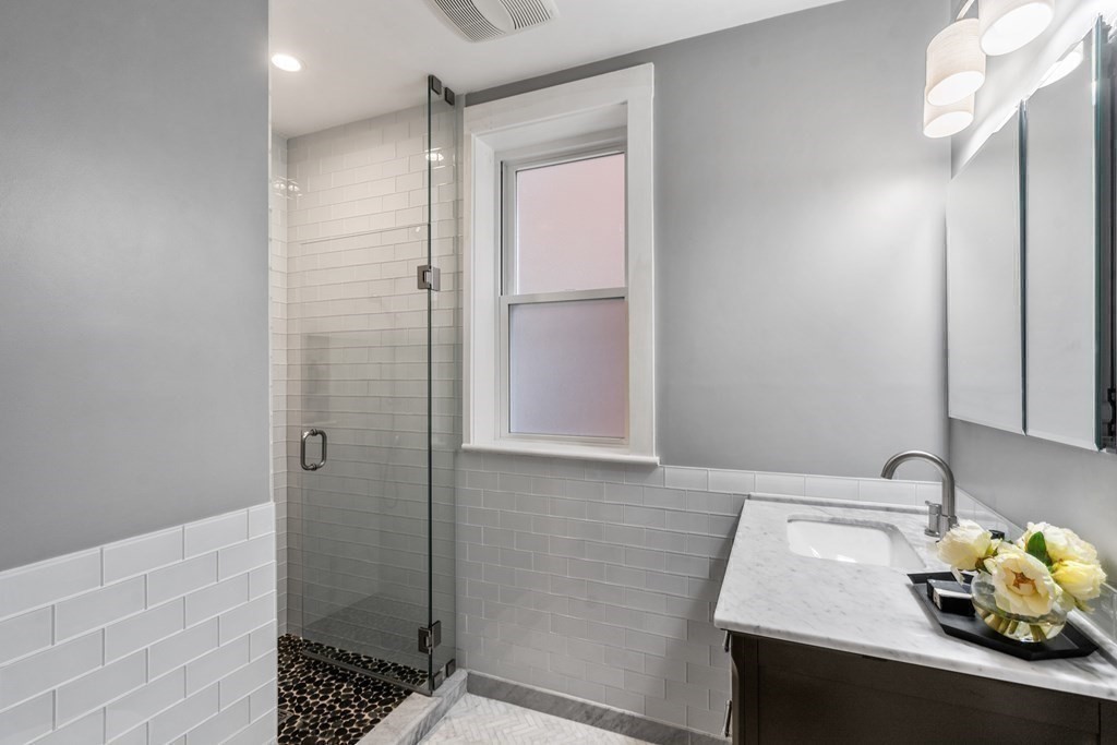 14 Warwick Road, Unit 1 Brookline, MA 02445 - Photo 9 of 29 a bathroom with a sink and a shower
