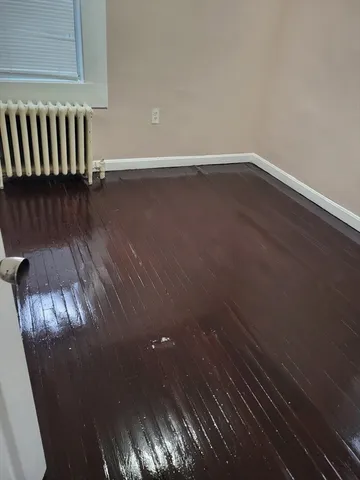 a view of room with wooden floor