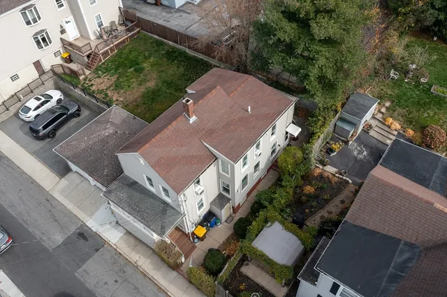 an aerial view of a house with a yard