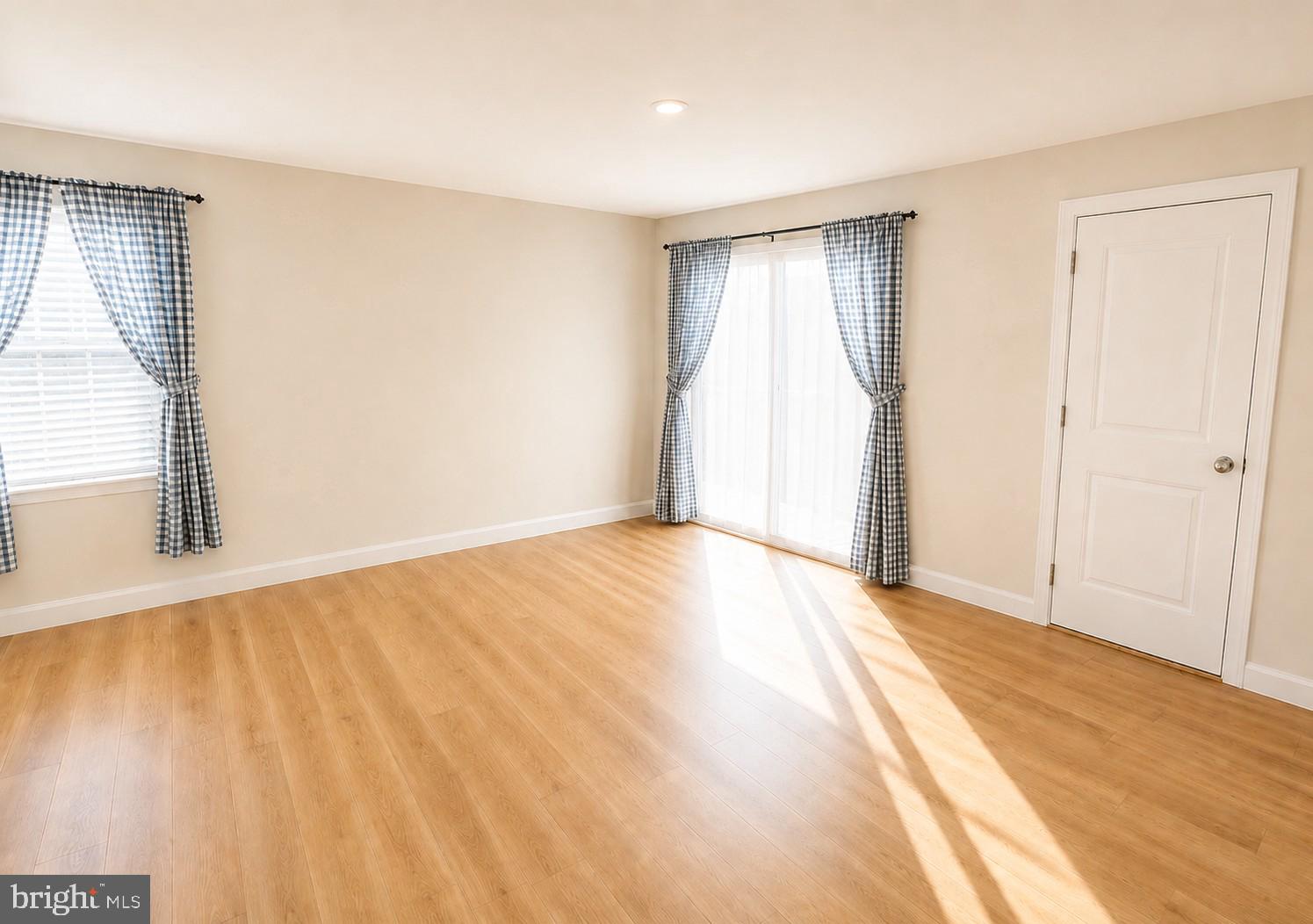 17854 Meriwether Lewis Street Ruther Glen, VA 22546 - Photo 11 of 35 a view of an empty room with wooden floor and a window