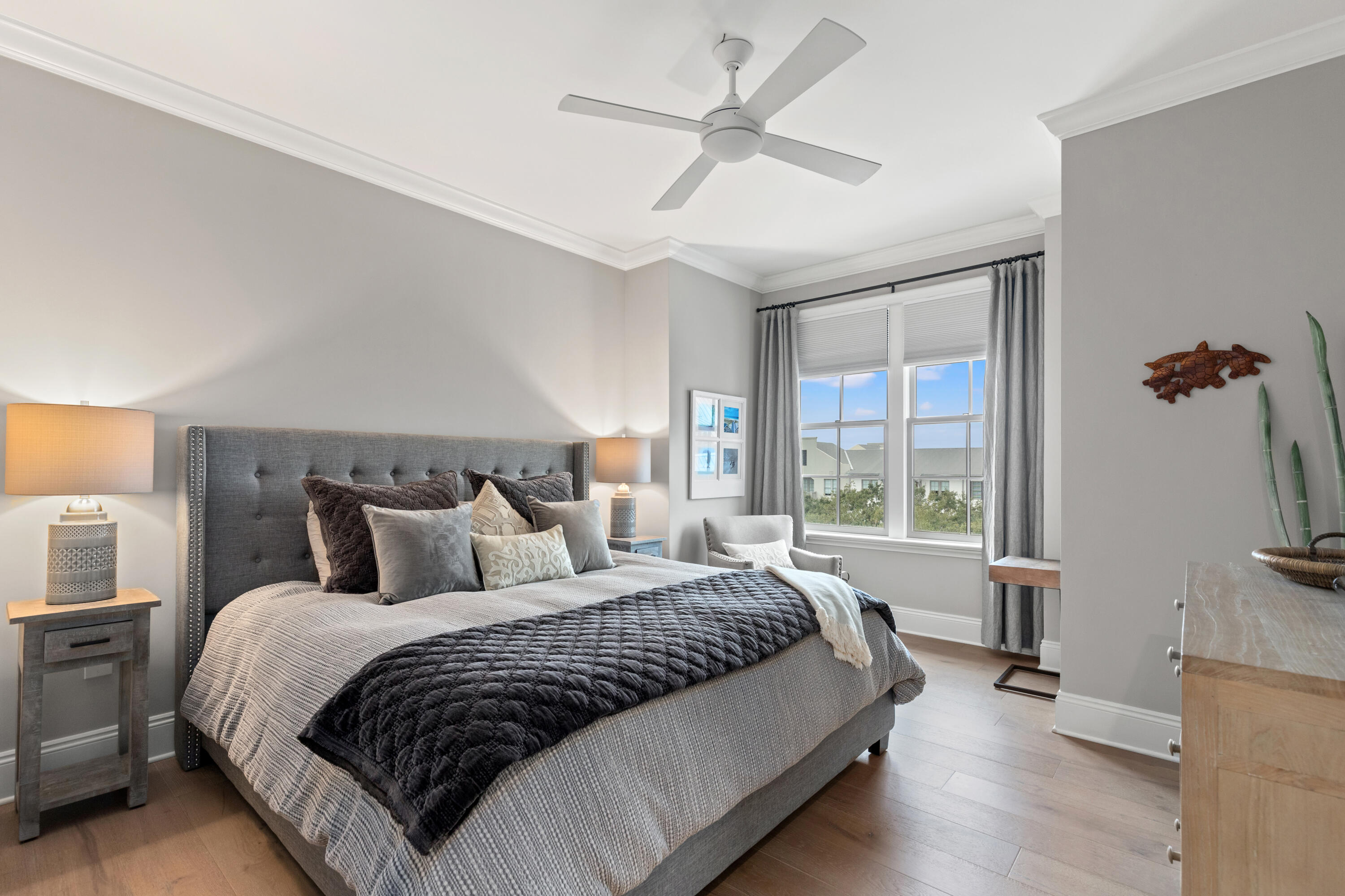 46 North Barrett Square, Unit 401 Inlet Beach, FL 32461 - Photo 11 of 34 a bedroom with a large bed and a chandelier fan