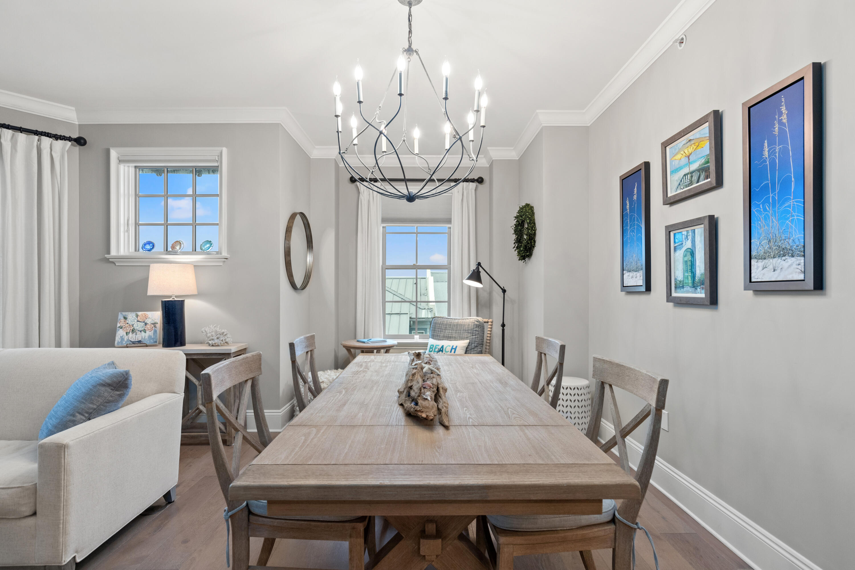 46 North Barrett Square, Unit 401 Inlet Beach, FL 32461 - Photo 4 of 34 a view of a dining room with furniture a chandelier and wooden floor