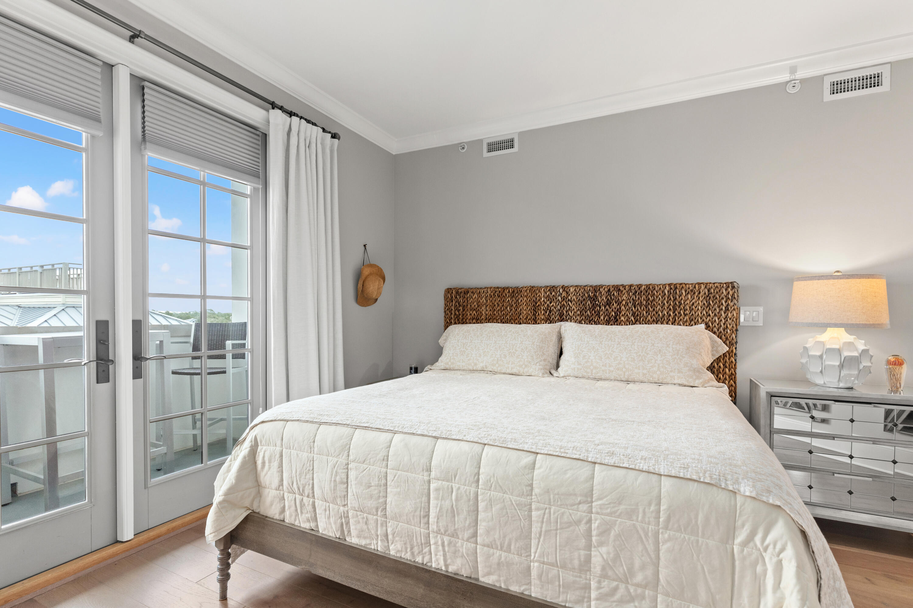 46 North Barrett Square, Unit 401 Inlet Beach, FL 32461 - Photo 8 of 34 a large bed sitting in a bedroom next to a window