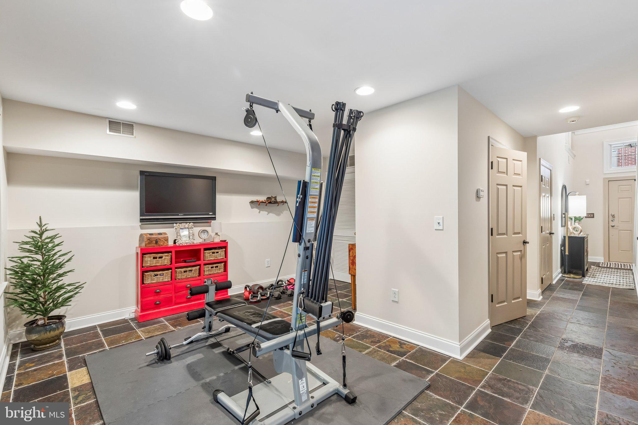 852 Independence Court Philadelphia, PA 19147 - Photo 5 of 31 a room with gym equipment and a flat screen tv