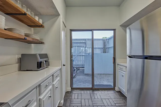 a kitchen with a refrigerator and cabinets