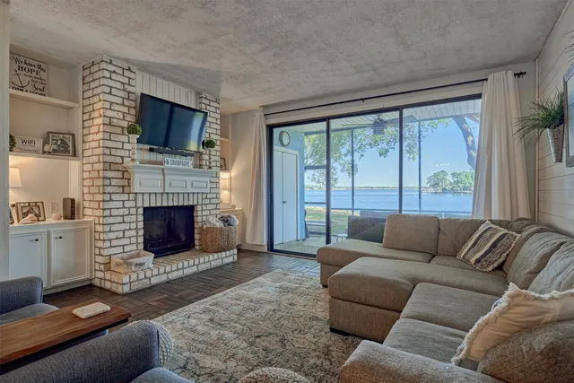 a living room with furniture large window and a fireplace