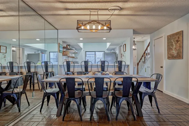a large kitchen with lots of furniture and a chandelier