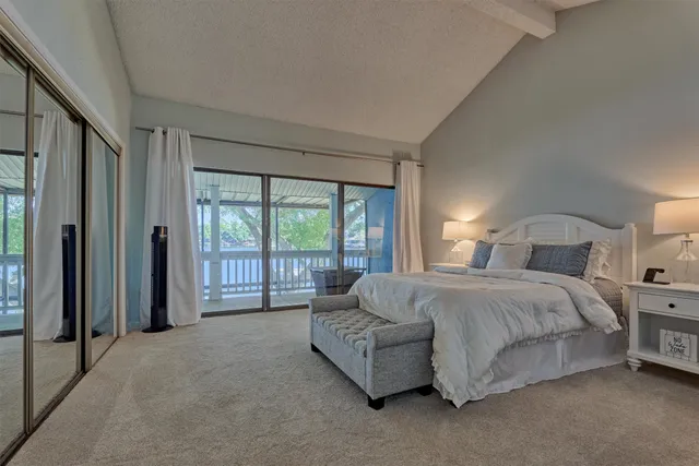 a spacious bedroom with a bed and a large window