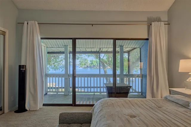 a bedroom with a bed and a large window