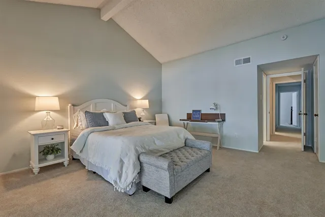 a bedroom with bed and a lamp