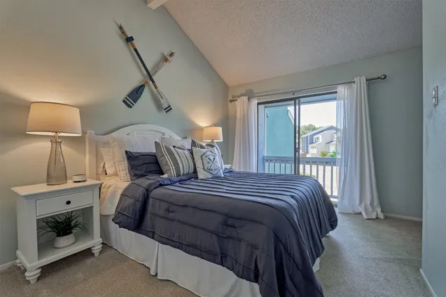 a bedroom with a bed and a lamp