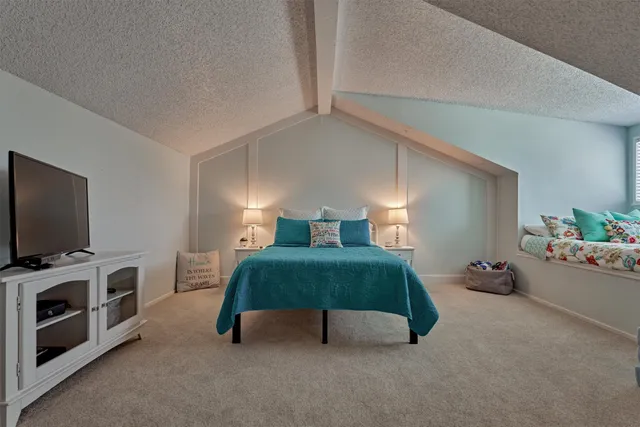 a bedroom with furniture and a flat screen tv