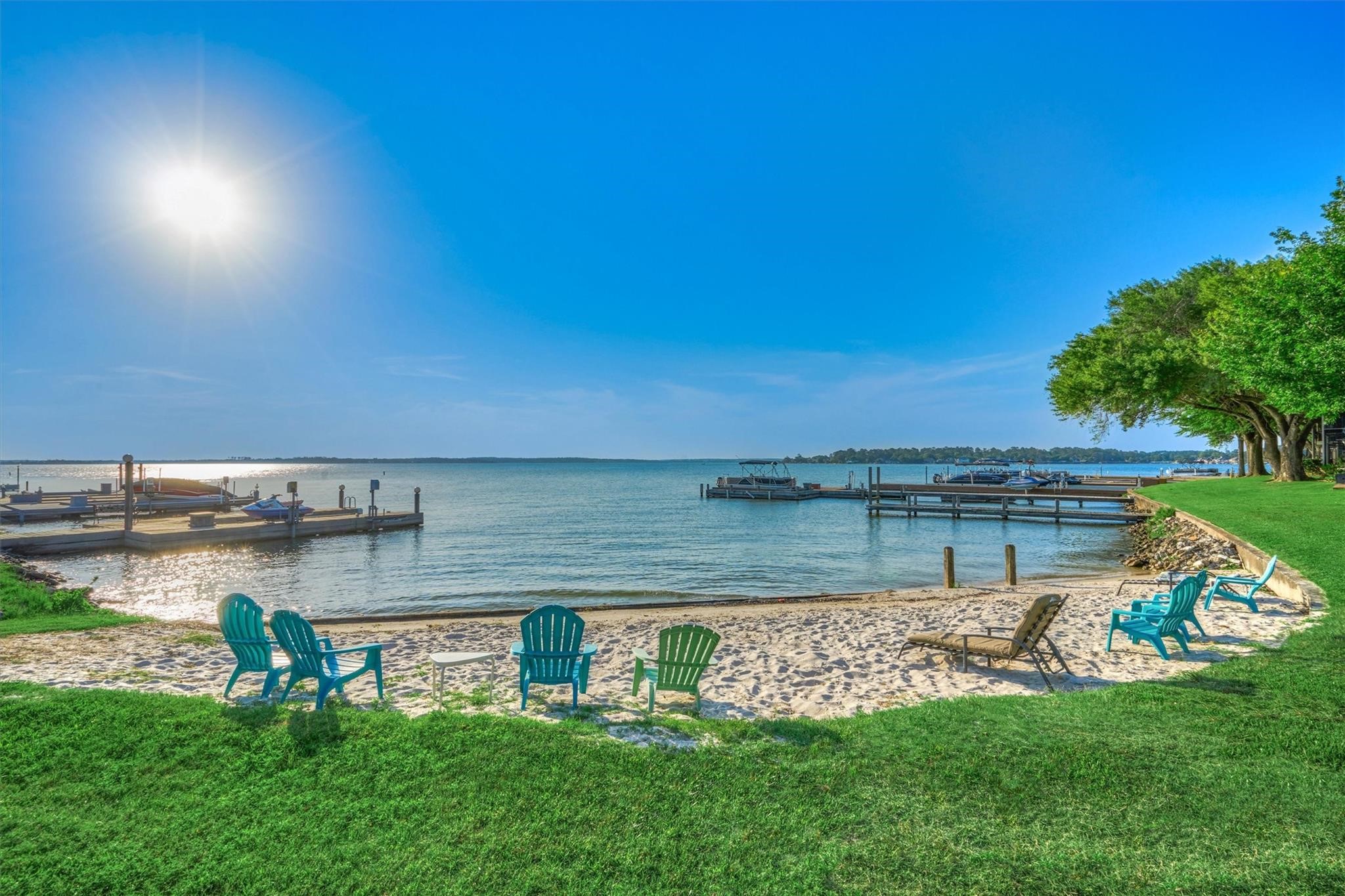 1428 Bowsprit Point Willis, TX 77318 - Photo 46 of 47 a view of a lake with lawn chairs and a large tree