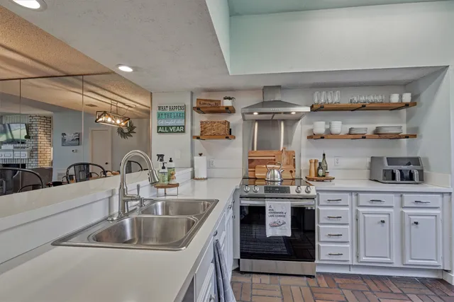 a kitchen with stainless steel appliances granite countertop a sink and stove