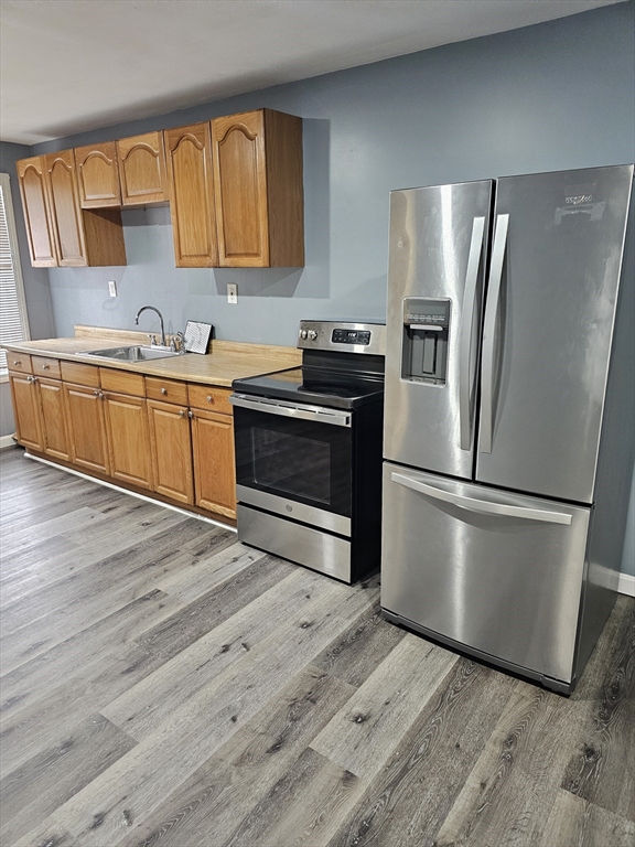 a kitchen with wooden cabinets and stainless steel appliances
