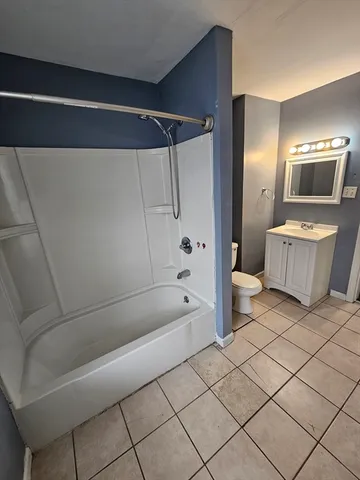 a bathroom with a bathtub and shower