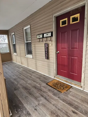 a view of a livingroom with wooden floor and windows