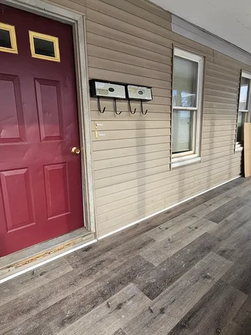 a view of a house with a door and wooden floor
