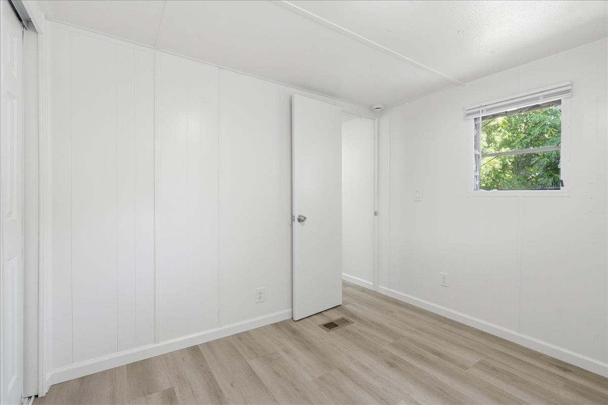1525 Cold Springs Road, Unit 48 Placerville, CA 95667 - Photo 13 of 23 a view of an empty room with wooden floor and a window
