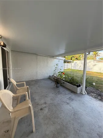 a view of a room with gym equipment and windows
