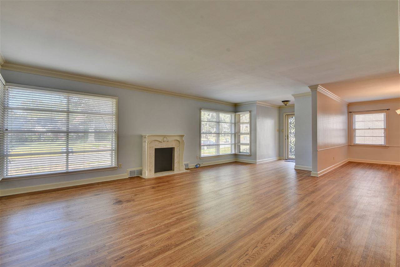 4053 Minden Road Memphis, TN 38117 - Photo 4 of 22 an empty room with wooden floor and windows