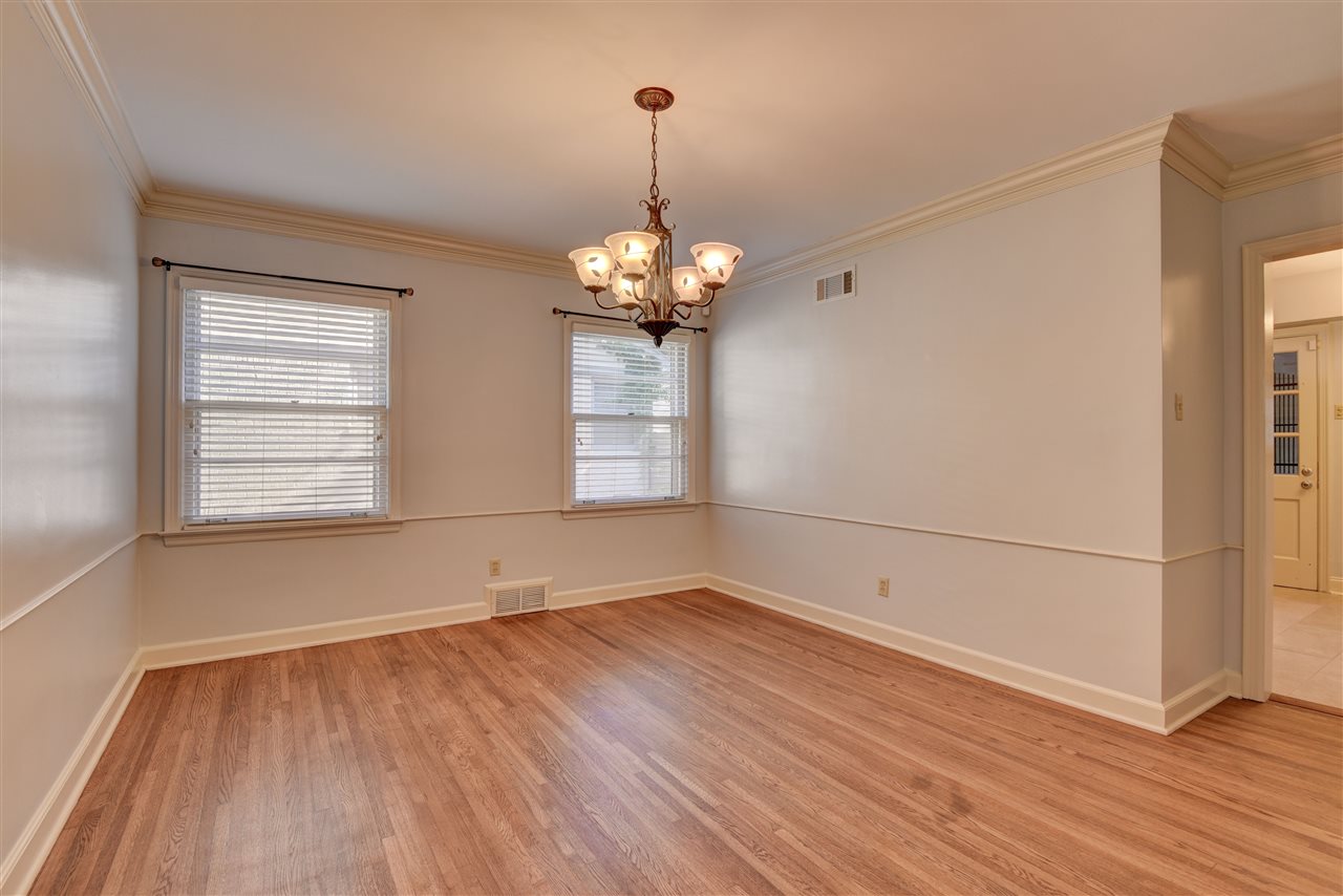 4053 Minden Road Memphis, TN 38117 - Photo 5 of 22 an empty room with wooden floor and windows