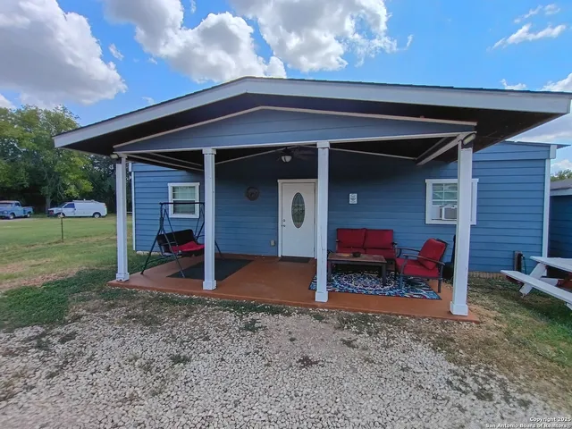 a view of a house with a backyard