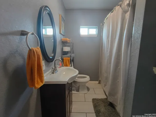 a bathroom with a sink a mirror and a toilet
