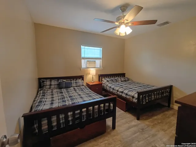 a bedroom with two beds and a chandelier