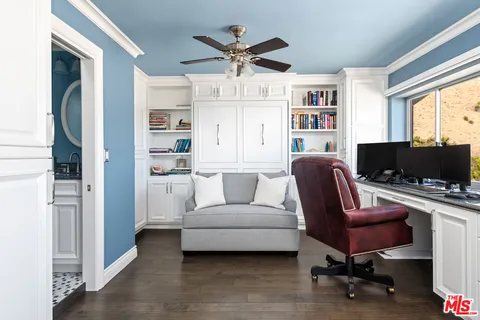 a living room with furniture a flat screen tv and a window
