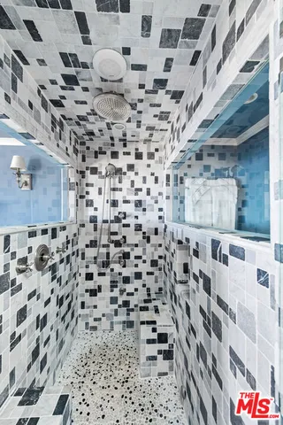 a bathroom with a shower and a sink