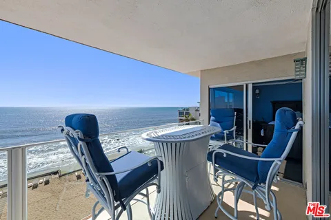 a view of a dining room with furniture and a potted plant