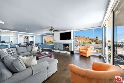 a living room with furniture flat screen tv and a fireplace