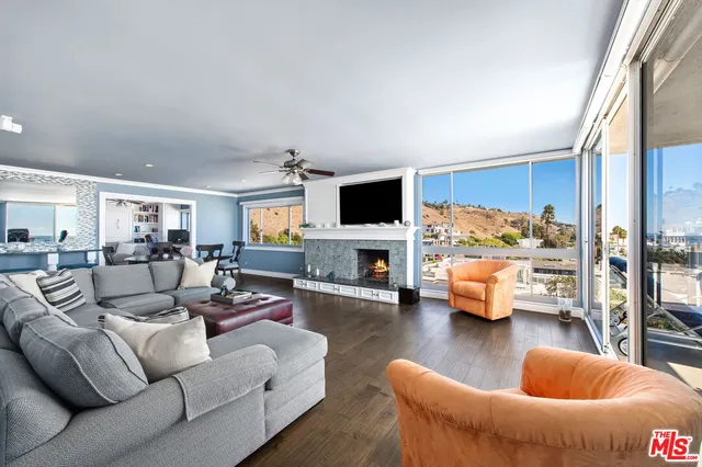 a living room with furniture flat screen tv and a fireplace