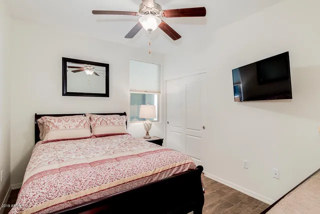 a bedroom with a bed and a flat screen tv