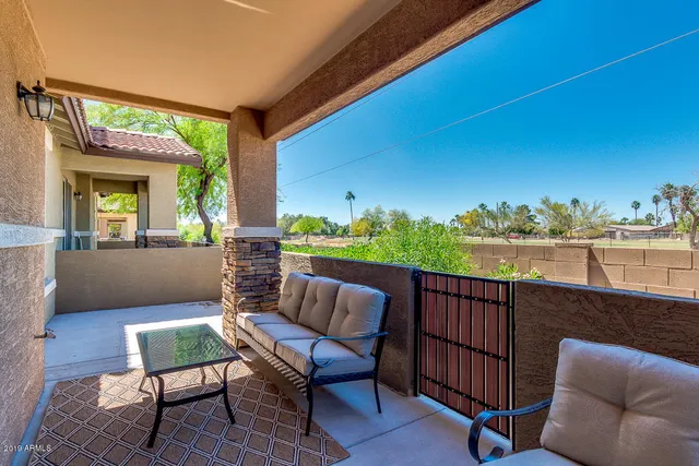 a roof deck with couches and potted plants
