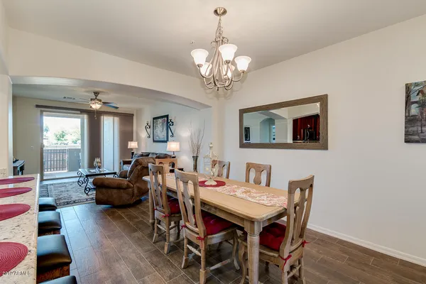 a view of a dining room with furniture wooden floor and chandelier