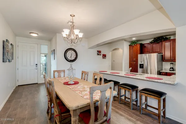 a view of a dining room and a table chairs a chandelier a wooden table and chairs