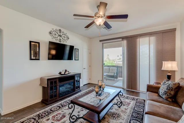 a living room with furniture a rug and a flat screen tv