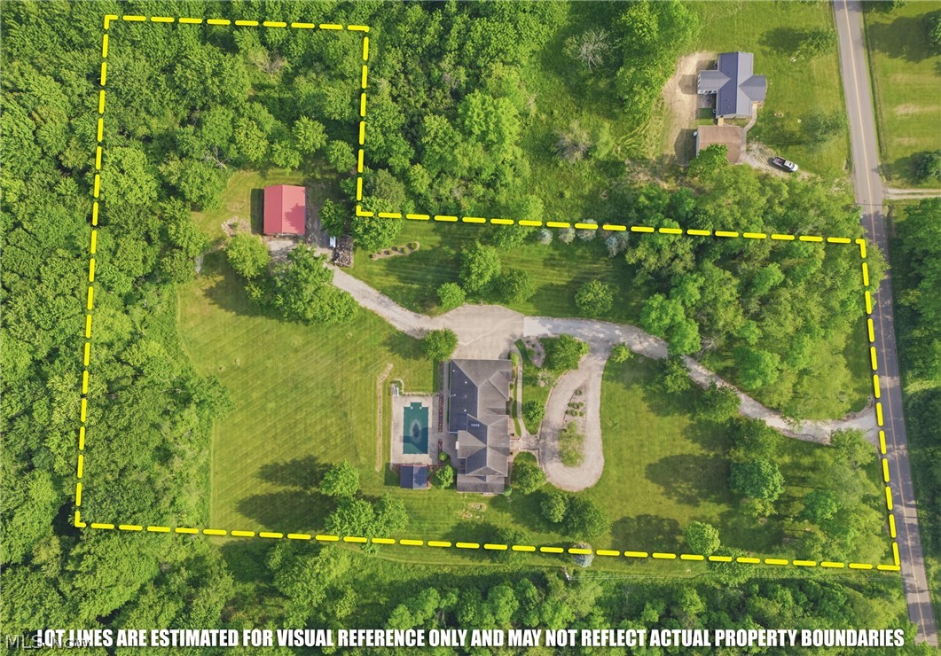 2184 Brenner Road Northeast Carrollton, OH 44615 - Photo 50 of 50 Expansive property featuring a main residence with a swimming pool, a separate secondary structure with a red roof, a gravel driveway, and surrounding mature trees