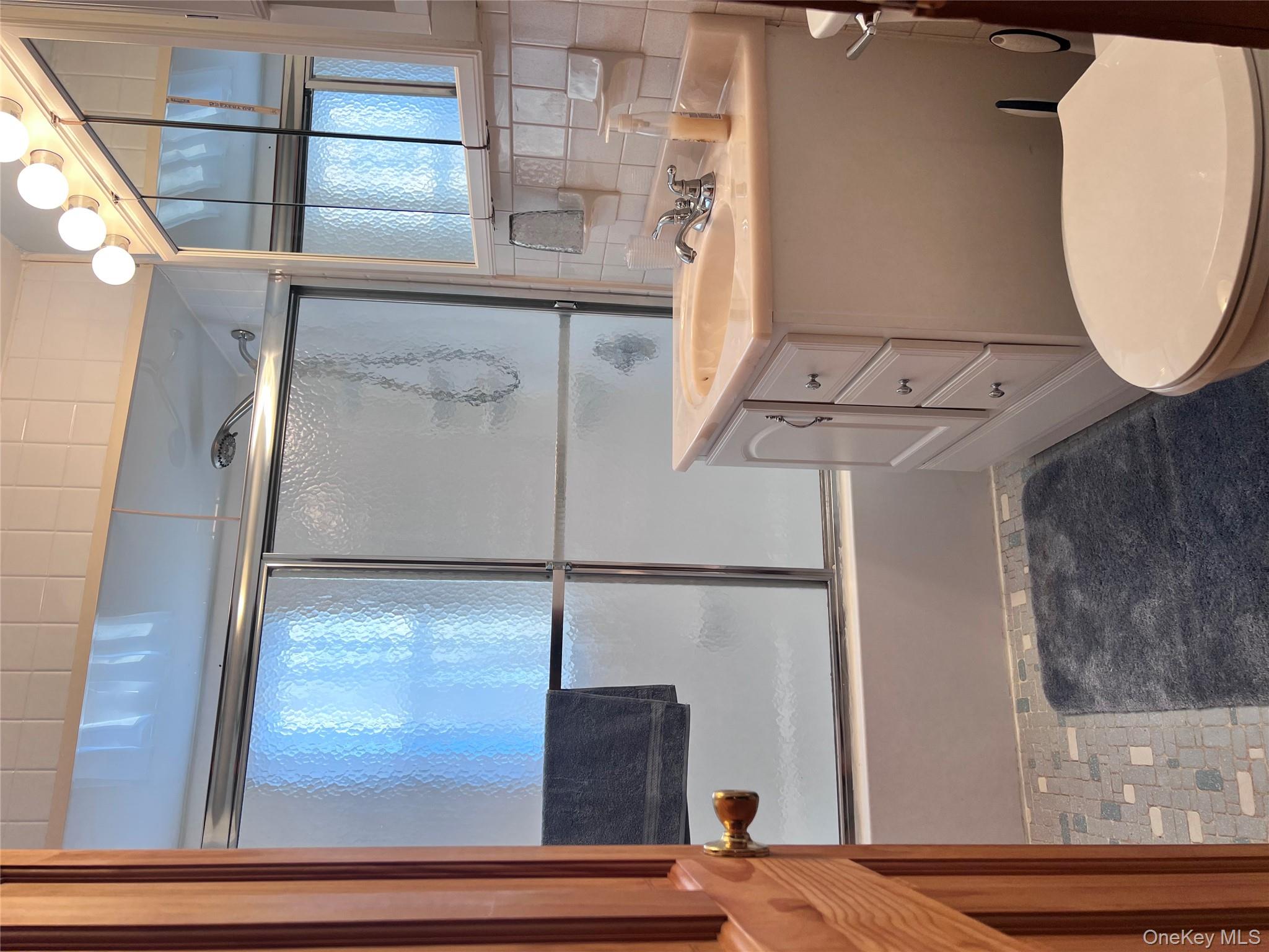 13 Herlings Road Wurtsboro, NY 12790 - Photo 13 of 37 a bathroom with a sink a toilet a mirror and window