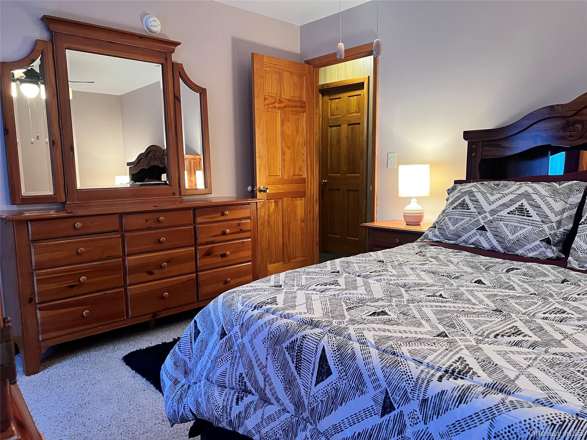 13 Herlings Road Wurtsboro, NY 12790 - Photo 15 of 37 a bedroom with a bed and a dresser