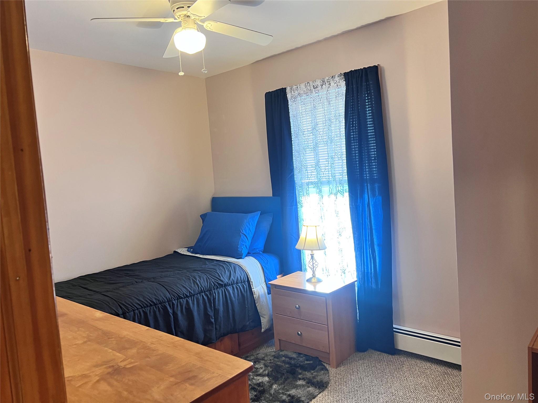 13 Herlings Road Wurtsboro, NY 12790 - Photo 22 of 37 a bedroom with a bed and a chandelier