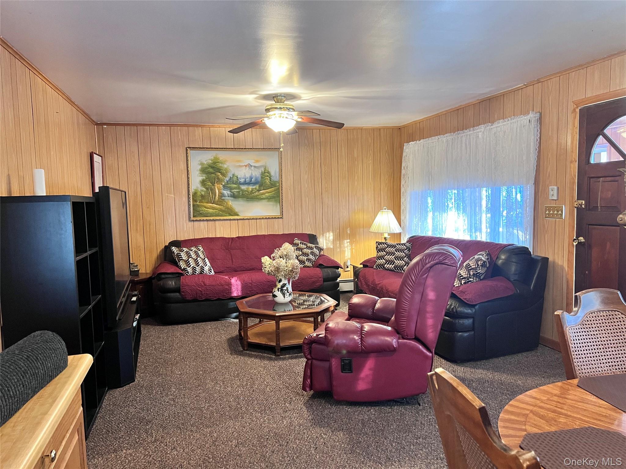 13 Herlings Road Wurtsboro, NY 12790 - Photo 5 of 37 a living room with furniture gym equipment and a flat screen tv
