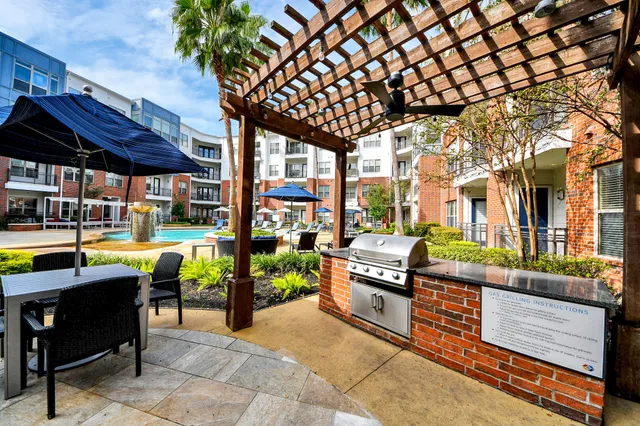 a view of a dining room and livingroom with furniture wooden floor a chandelier
