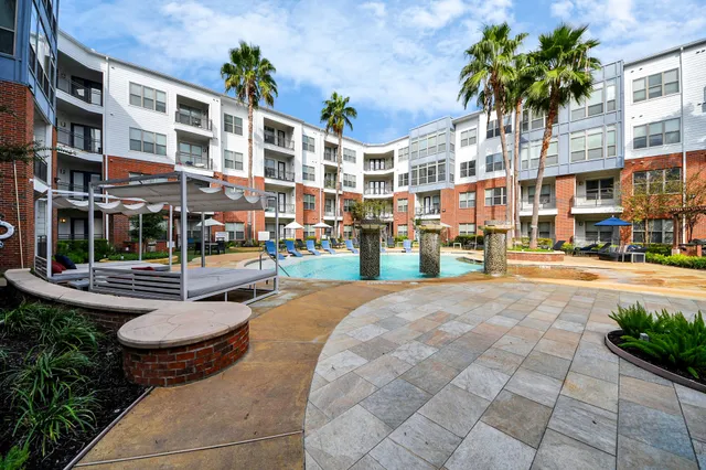 a en suite bathroom with a granite countertop tub and a large mirror